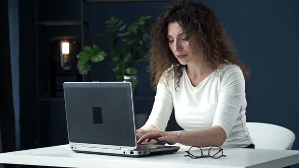 Portrait of a Beautiful Woman Working with Concentration at the Laptop