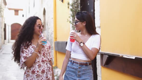 Multiethnic Teenage Girls Drinking Granita Frozen Drink on Summer Holidays