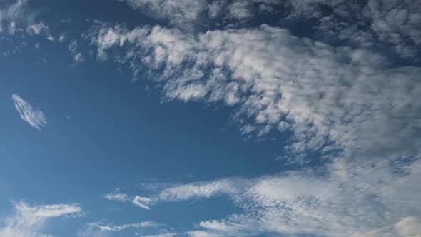 Rolling White Clouds in a Blue Sky Timelapse alt