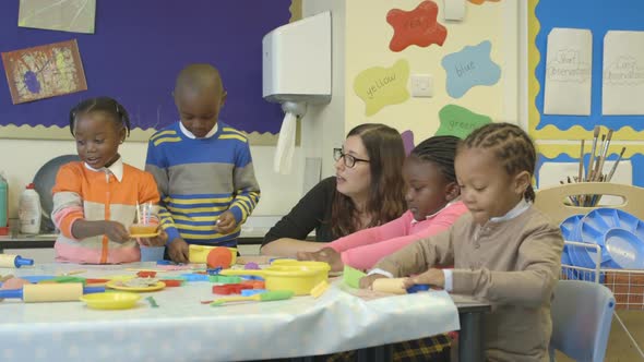 MS Teacher teaching to primary age student in classroom