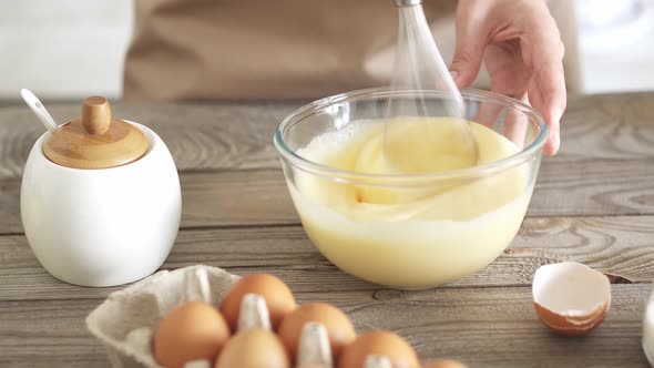 Girl Chef Whips The Ingredients For  Dough In Glass Beating Bowl With  Whisk. Homemade Dough Recipe alt