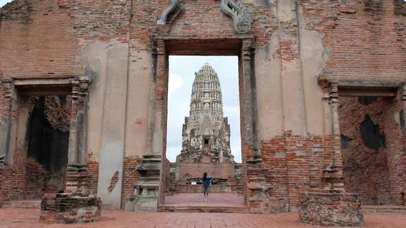 A woman with Action Camera traveling in ancient temple in Ayutthaya, Thailand