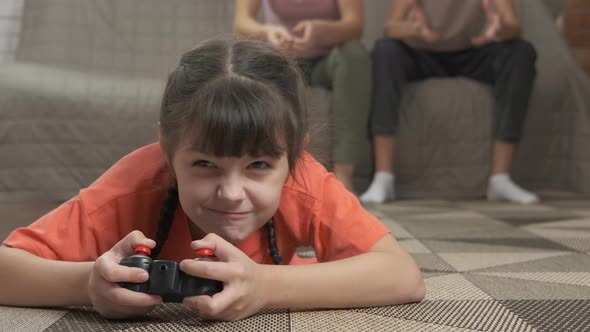Smiling child using joystick.  alt