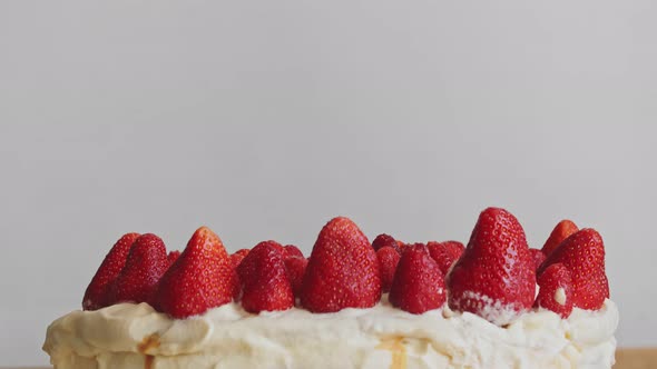 Decorating Homemade Strawberry Cake with Whipped Cream