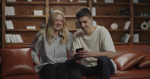 Husband Making Pictures of Her Wife on Mobile Phone alt