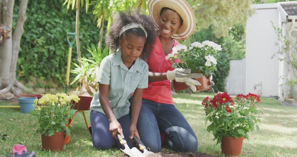 Mother and daughter gardening during a sunny day alt