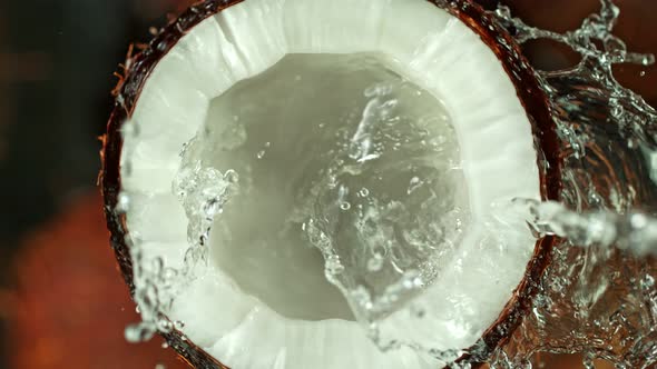 Super Slow Motion Shot of Splashing Water on Coconut at 1000Fps alt