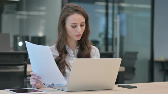 Young Businesswoman With Laptop Reacting to Failure on Documents alt