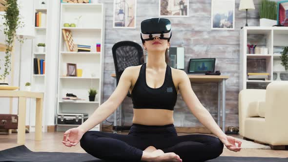 Beautiful Young Woman Wearing Virtual Reality Glasses Doing Yoga alt