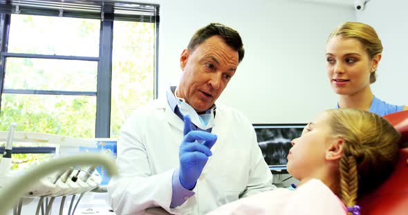 Dentist interacting with young patient alt