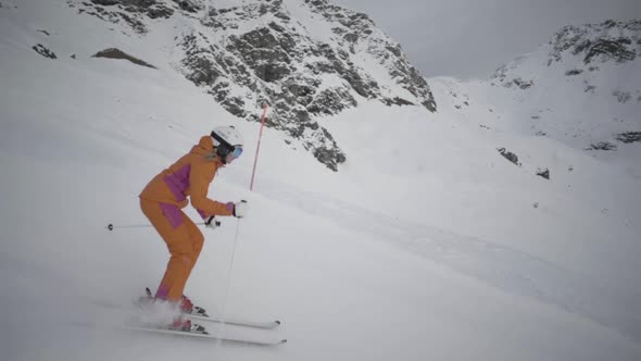 Slow Motion Woman Skiing in Short Swings on Ski Slope