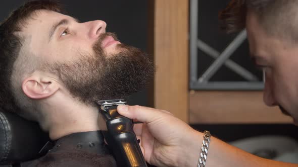 Barber Trimming Beard of Client