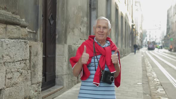 Happy Senior Male Tourist Dancing in City Center. Traveling in Lviv, Ukraine. alt