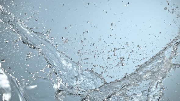 Super Slow Motion Shot of Side Water Splash on Blue Gradient Background at 1000Fps. alt