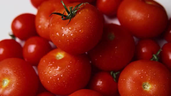 Washed Ripe Tomatoes on the White Background Close Up