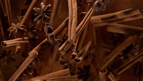 Super Slow Motion Shot of Cinnamon Star Anise and Powder Explosion on Black Background at 1000Fps alt