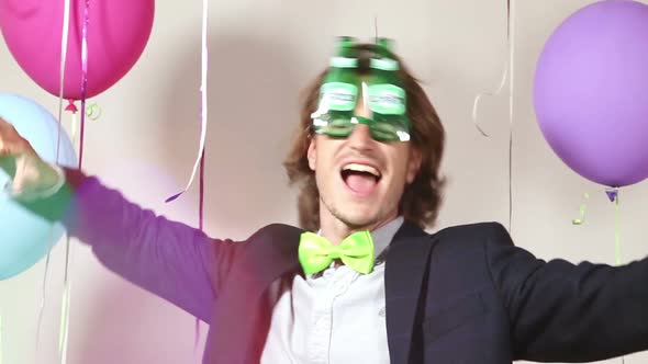 Funny man dancing wearing beer sunglasses in photo booth alt