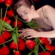Sexy Young Woman is Lying in Water with Red Tulips Seductive and Alluring Shot - VideoHive Item for Sale