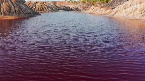 Aerial View of a Landscape Similar To the Planet Mars with Red Hills and Rivers with Red Water alt