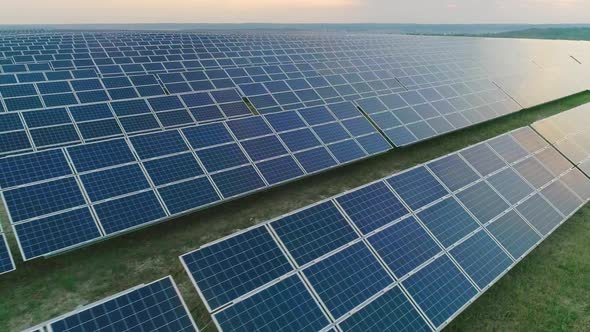 Aerial Drone View of Large Amount of Solar Power Panels on Energy Station Standing in Row. Concept alt