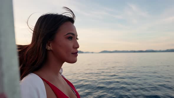 Woman Relaxing On Outrigger Boat Looking Away alt
