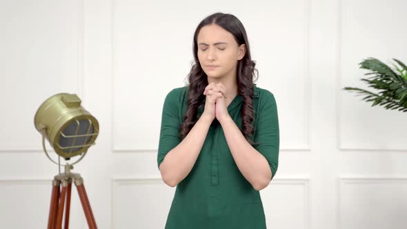 Afraid Indian girl praying alt