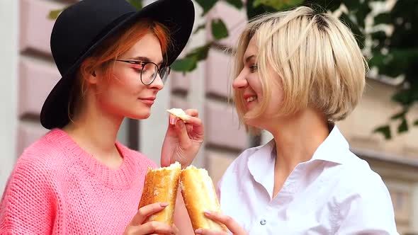 Two European Lesbain Woman Feed Each Other on a Loaf of Bread alt