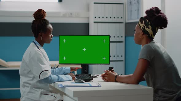 Medical Specialist Looking at Horizontal Green Screen alt