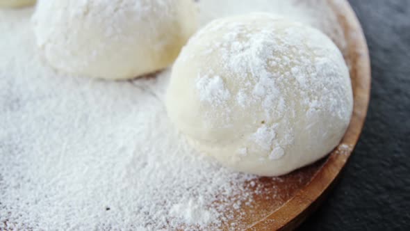 Pizza dough and flour on plate alt