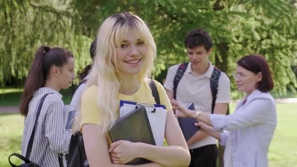 Female Student 16 17 Years Old with Digital Tablet Backpack in School Park alt