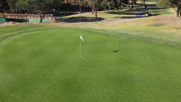 Aerial View of Flag Mark in Hole on Golf Field alt