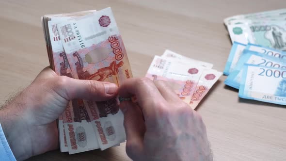 Closeup of Hands Counting Fivethousandth Banknotes of the Russian Ruble