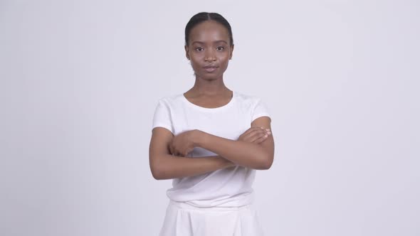 Young Happy African Woman Smiling with Arms Crossed alt