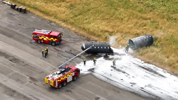 Firefighters Training to Tackle a Fire of a Dummy Aircraft alt