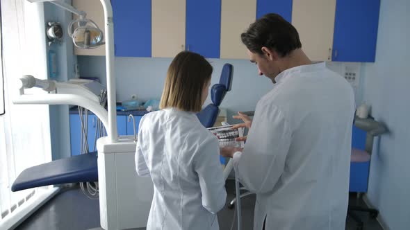 Back View of Dental Coworkers Using Tablet Pc alt