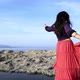 woman dancing in a red skirt by the sea - VideoHive Item for Sale