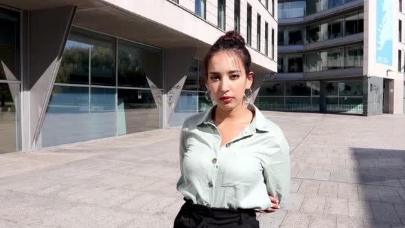 Young Entrepreneur Crossing arms while looking serious to camera, young women in business