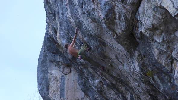 A man rock climbing up a mountain. alt