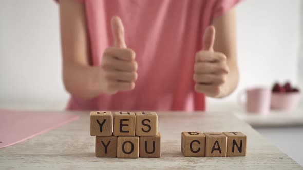 The Phrase Yes You Can Motivate To Success. The Young Woman Raised Her Thumbs In Front Of Her alt