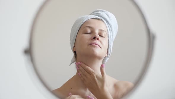 Caucasian female slow motion in front of make-up mirror 1920X1080 HD footage - Woman applying  cream alt