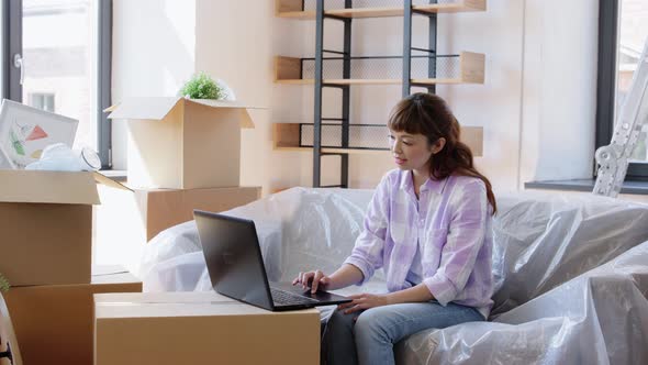 Woman with Laptop Moving Into New Home alt