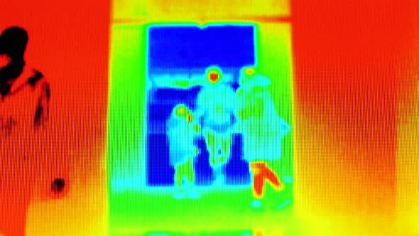 Covid-19 Prevention, Coronavirus Concept. Thermal Image of People Passing Through a Public Area alt