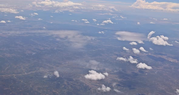 View From Plane During Flight Over of Fluffy Clouds desertNew Mexico USA alt