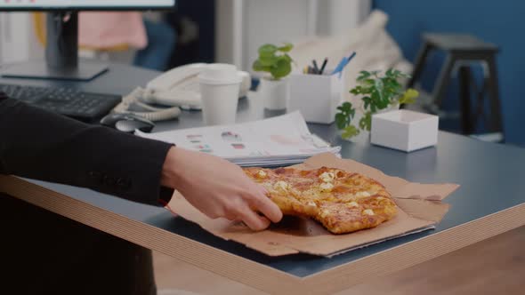 Closeup of Executive Manager Taking Slice of Pizza Eating in Front of Computer Typing Financial alt