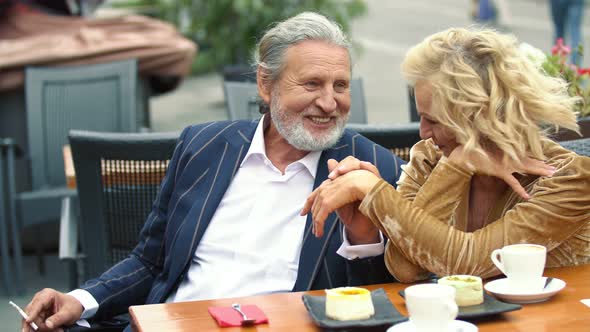 Elderly Couple Sitting at the Table alt