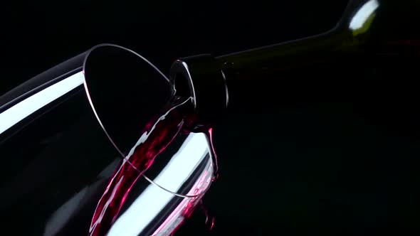 Red Wine Being Poured Into a Glass, Black, Closeup, Slowmotion alt