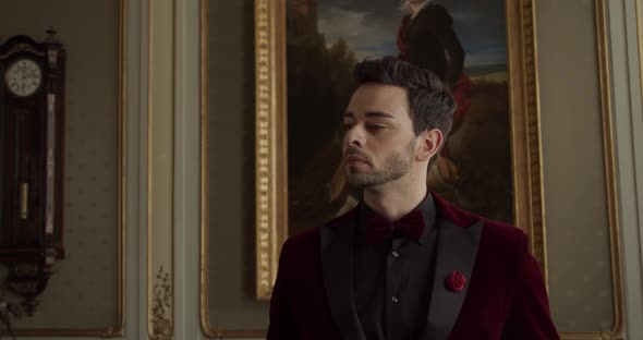 Young Guy Looking At Paintings In The Gallery alt