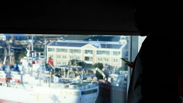 Businessman talking on mobile phone in hotel room  alt