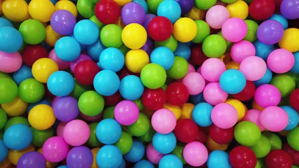 Background, plastic multi-colored balls. View from above. Children's dry ball pool.