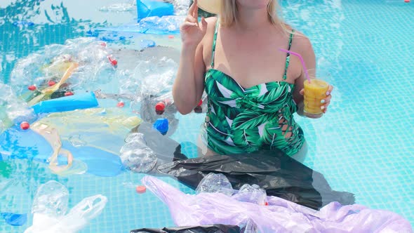 Concept of Pollution of the Planet. Young Shocked Woman Swims Among the Trash alt